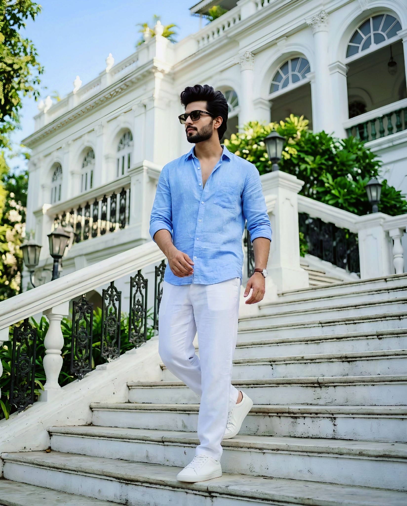 Ultra-realistic full-body portrait of a young man walking down a wide outdoor staircase of a grand w
