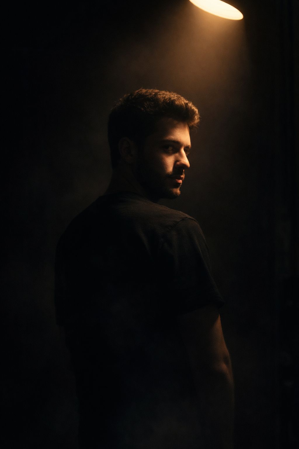 Ultra-realistic studio portrait of a young man using the exact face from the reference image, mainta