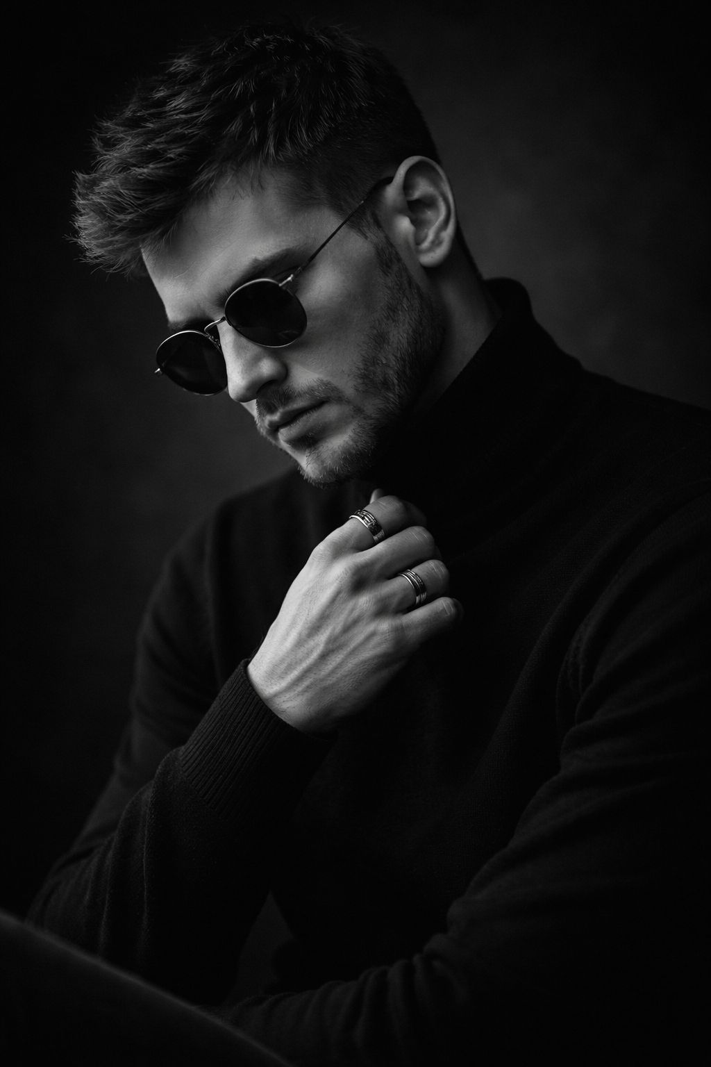 Ultra-realistic 8K cinematic black-and-white portrait of a young man, STRICT pose: sitting with body