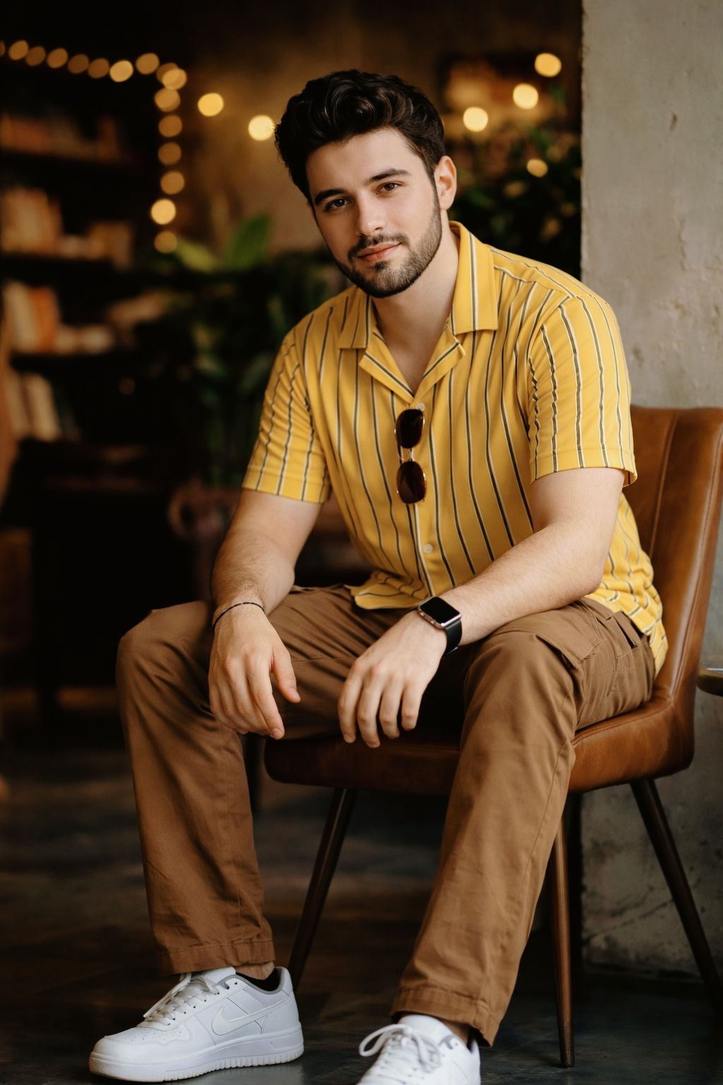 Ultra-realistic 8K portrait of a young man sitting on a modern chair, STRICT pose: seated slightly f