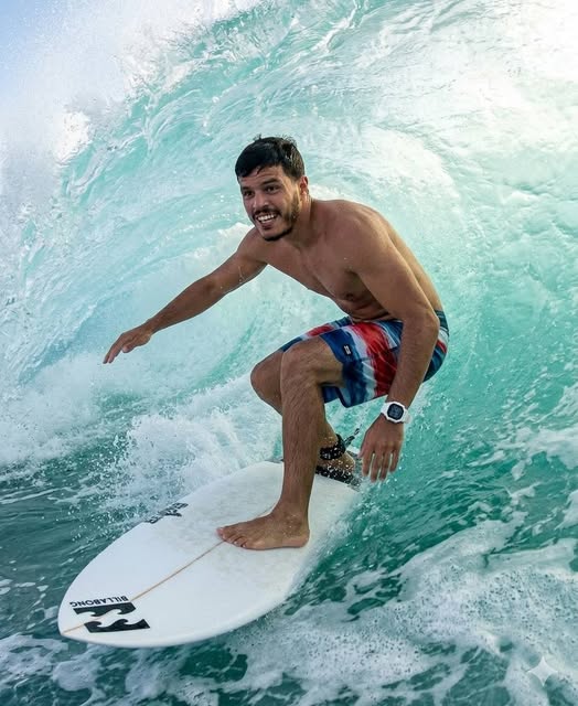 The subject is a man with athletic build. He is shirtless, only wearing mid-thigh length board short