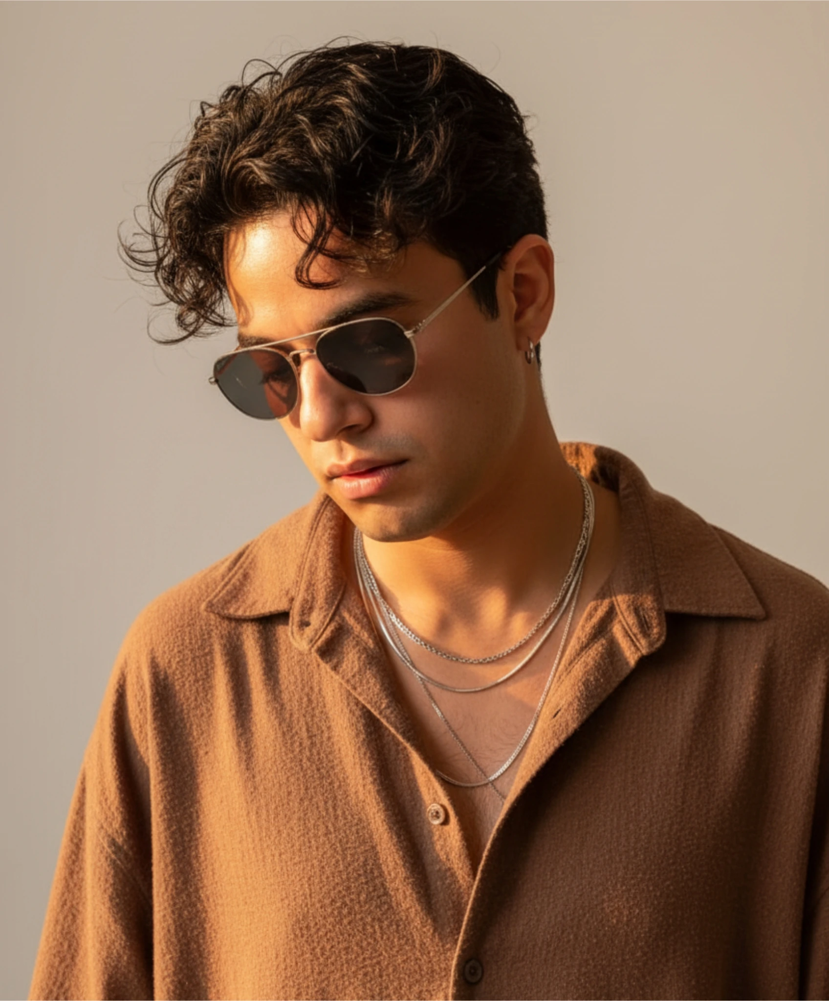 \"Dreamlike cinematic portrait of a young man with tousled black hair, wearing an earthy brown overs