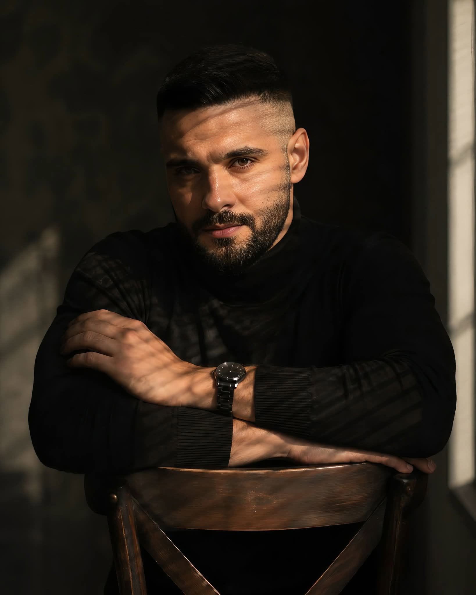 Ultra-realistic cinematic portrait of a confident bearded man sitting backward o — Google Gemini AI Image Prompt