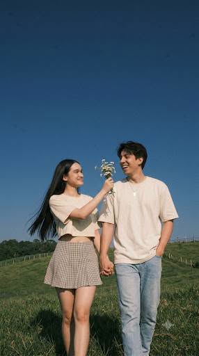 Create image: A young Asian couple [attached references] in their twenties, both — DALL-E AI Image Prompt