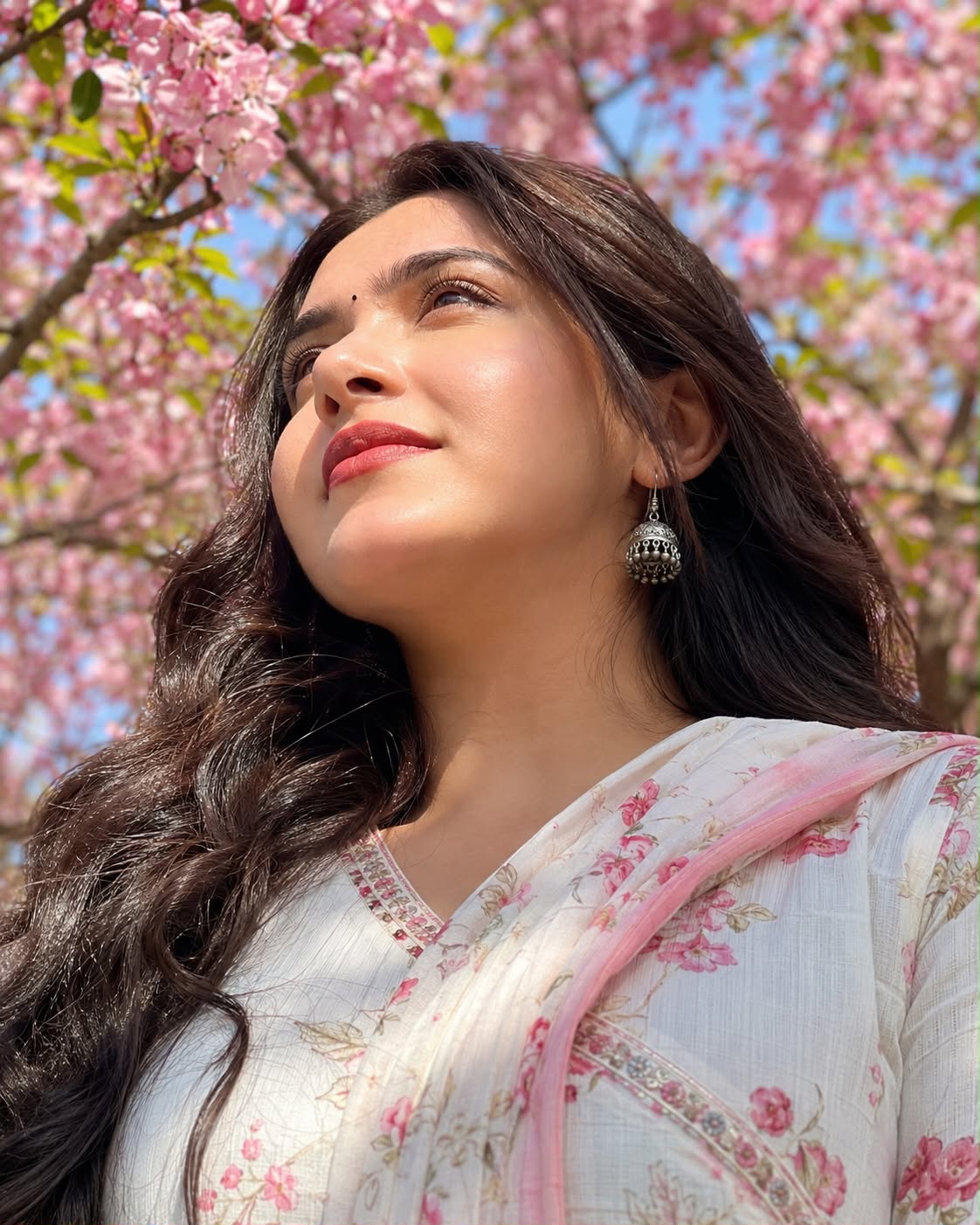 \"A low-angle, close-up portrait of a beautiful South Asian woman with long, wav — Google Gemini AI Image Prompt