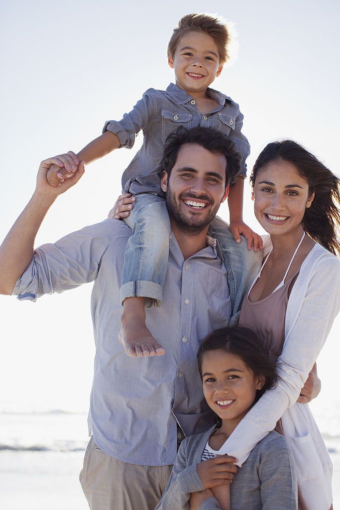 ultra photorealistic candid happy family lifestyle portrait on a sunny beach, fo — Google Gemini AI Image Prompt
